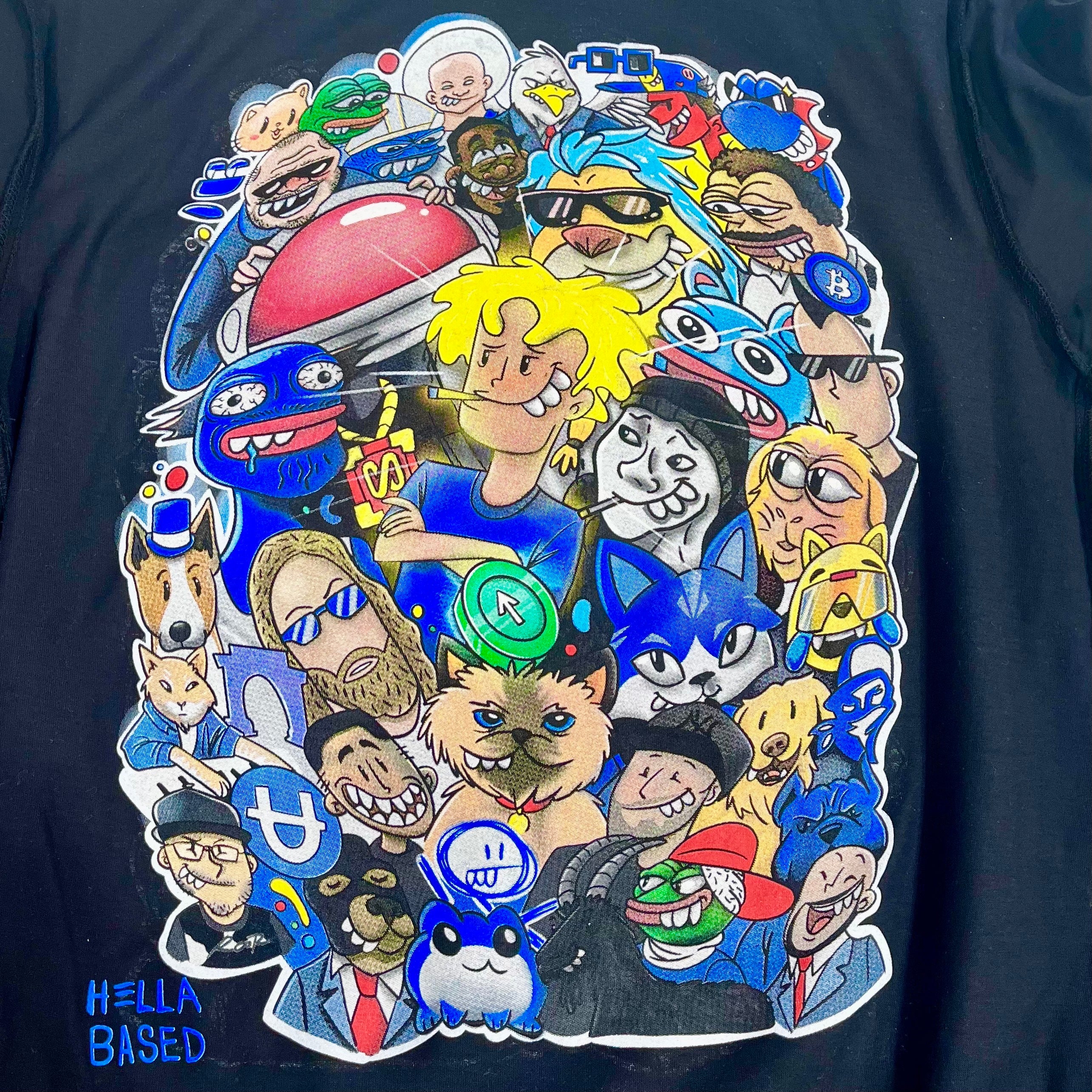 Vibrant cartoon characters and internet memes leap off a black backdrop on the Base Fame Day Tee by Other. Featuring exaggerated expressions, the design is lively and dense. The playful phrase "Hella Bays'd All-Star Weekend" in the bottom left corner adds a unique touch.