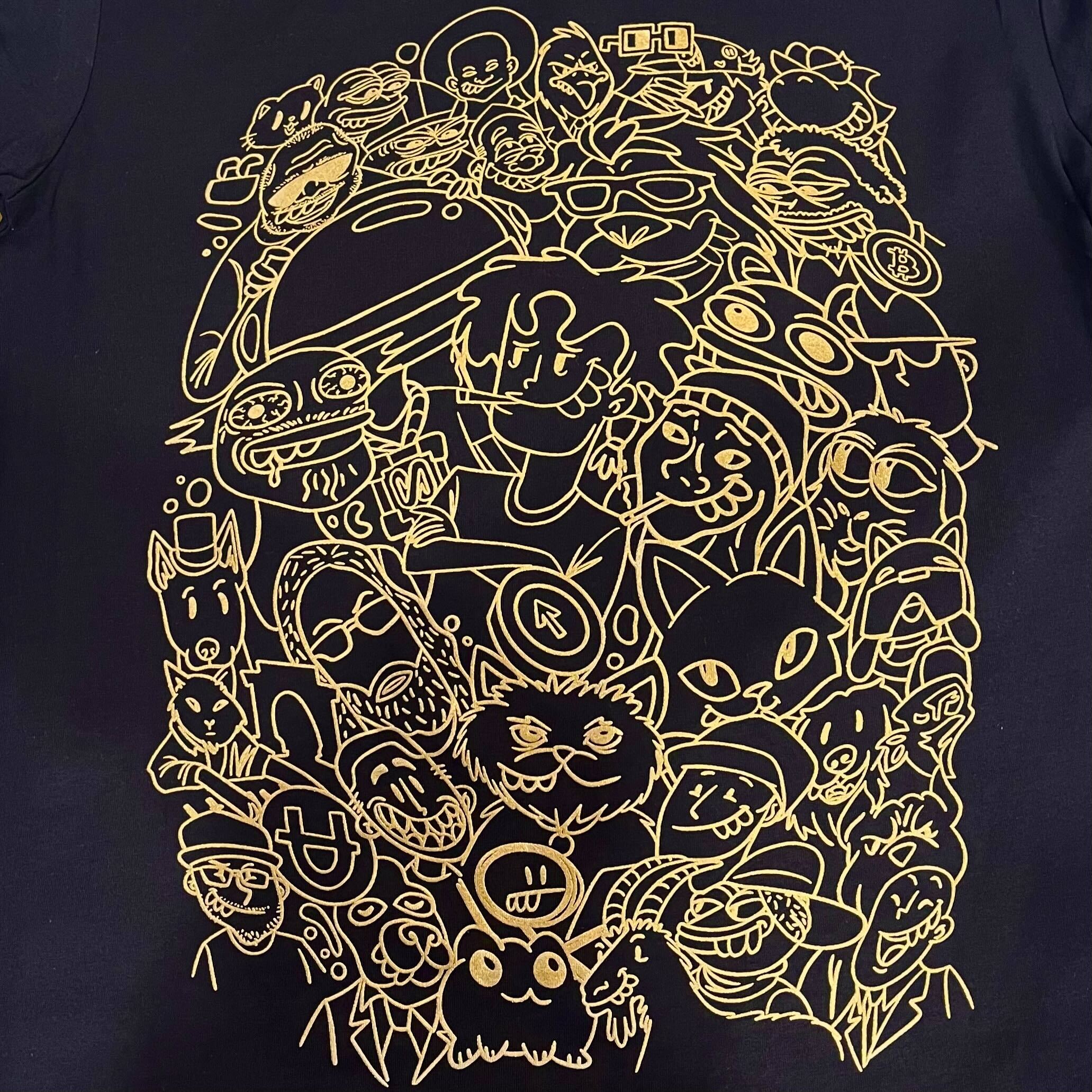 The Base Fame Night Tee by Oaklandish features intricate gold line illustrations of cartoon faces, animal characters, and abstract shapes on a black background. The dense, playful design embodies the lively spirit of the Hella Bays'd All-Star Weekend.