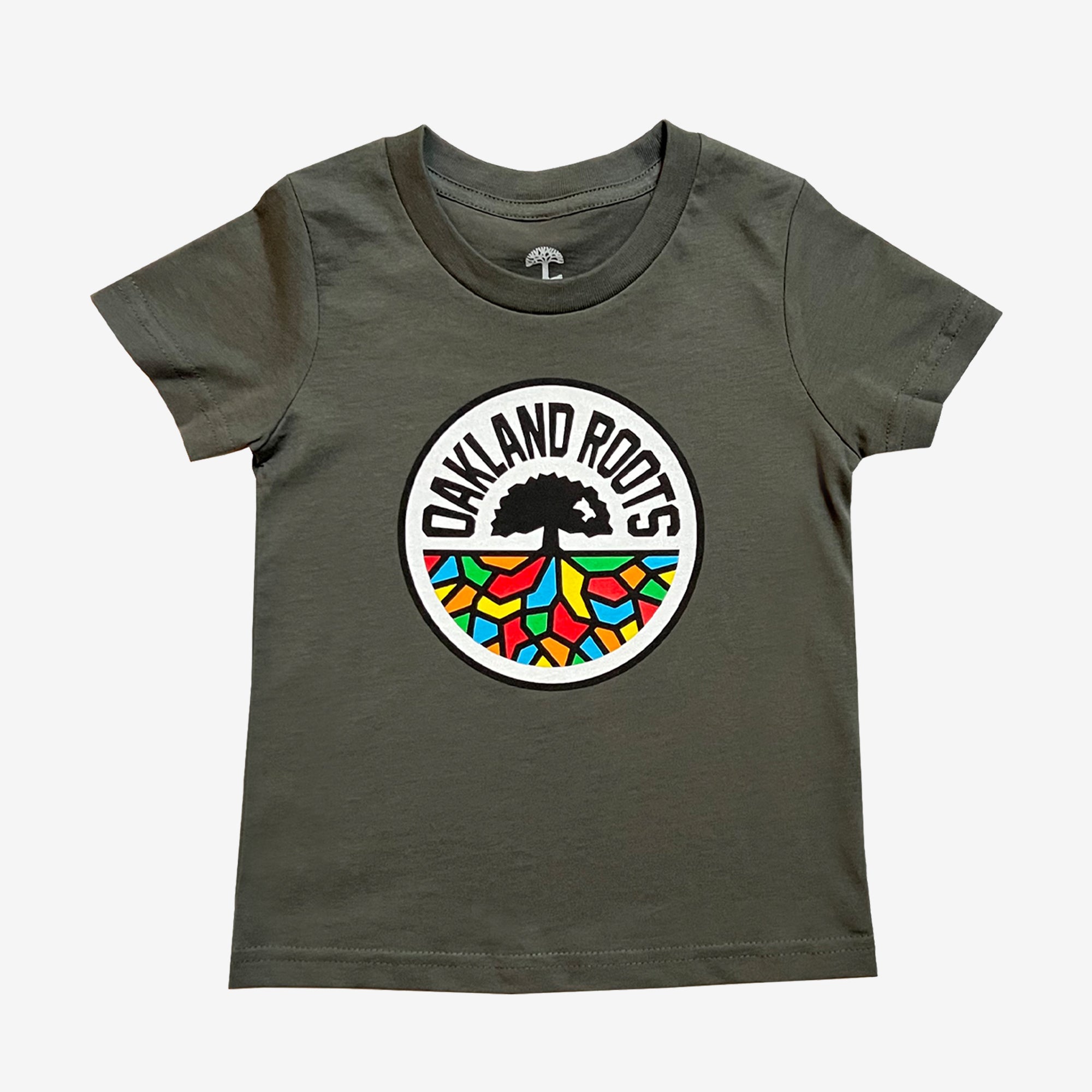 The Toddler Oakland Roots SC Classic Tee by Oakland Roots SC is a dark gray short-sleeve t-shirt that showcases the sports club logo on the chest. The logo features a black tree with sprawling roots set against a white circular background, where the roots are artistically depicted in vibrant colors of red, yellow, green, and blue to form a geometric pattern.