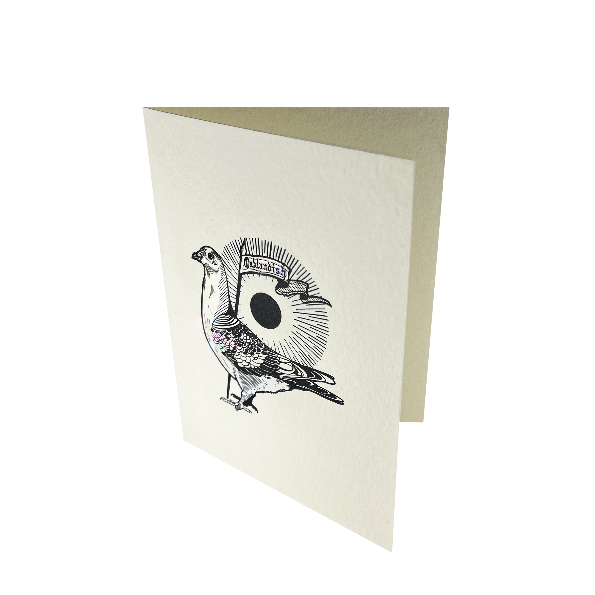 The Oaklandish Pigeon Card by Never Elsewhere is a folded greeting card crafted from recycled paper. It showcases a detailed illustration of a pigeon adorned with a crown and body armor, holding a flag with text. An eye design forming a circular halo is positioned above and behind the pigeon. The card itself is white and features a textured letterpress finish.