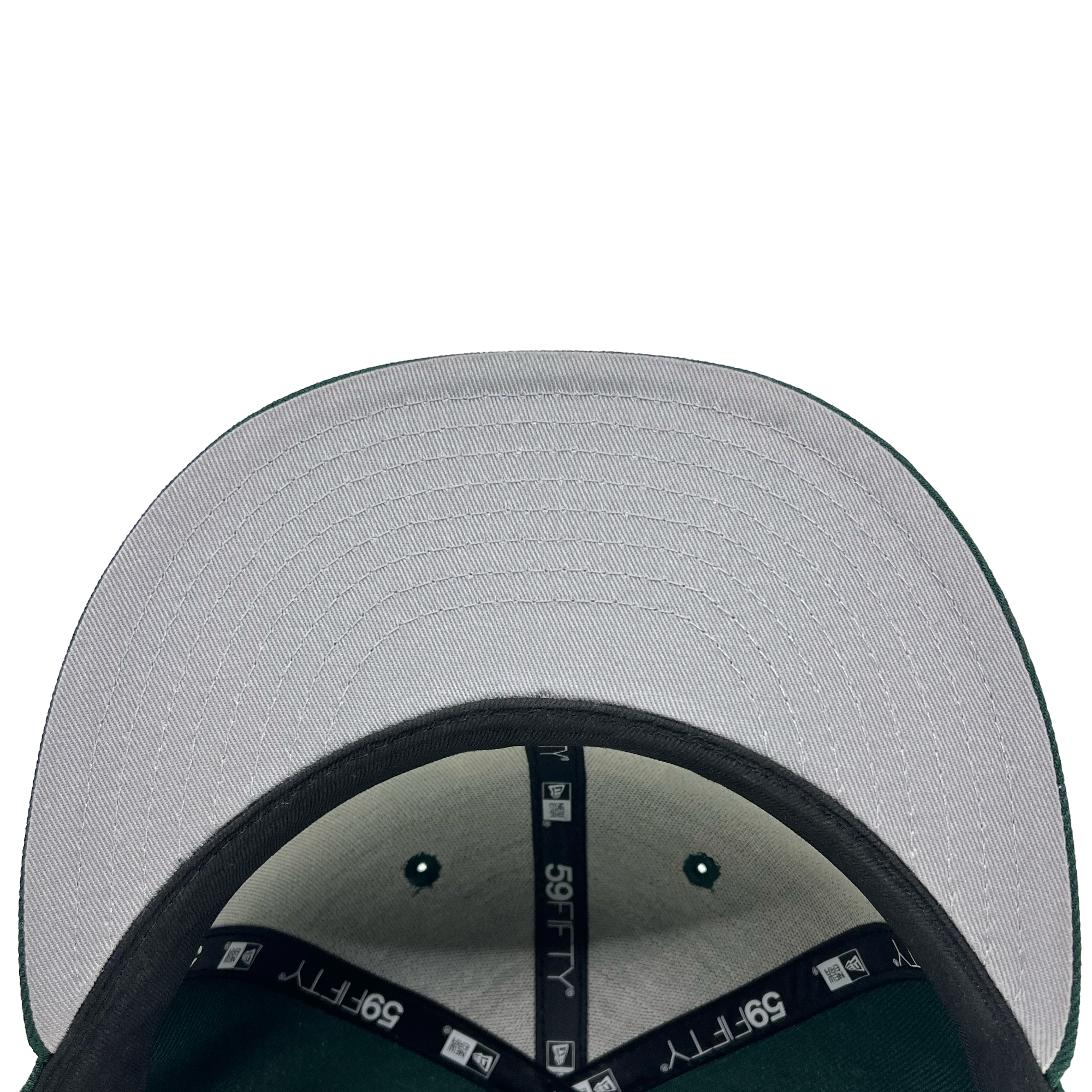 Close-up of the underside of an Oakland Ballers New Era 59FIFTY Cap's brim showcasing the green exterior fabric and a grey interior. "59FIFTY" is printed on the inner tape that lines the cap's interior. The stitching is detailed and visible, indicating quality craftsmanship, perfect for any Oakland Ballers fan.