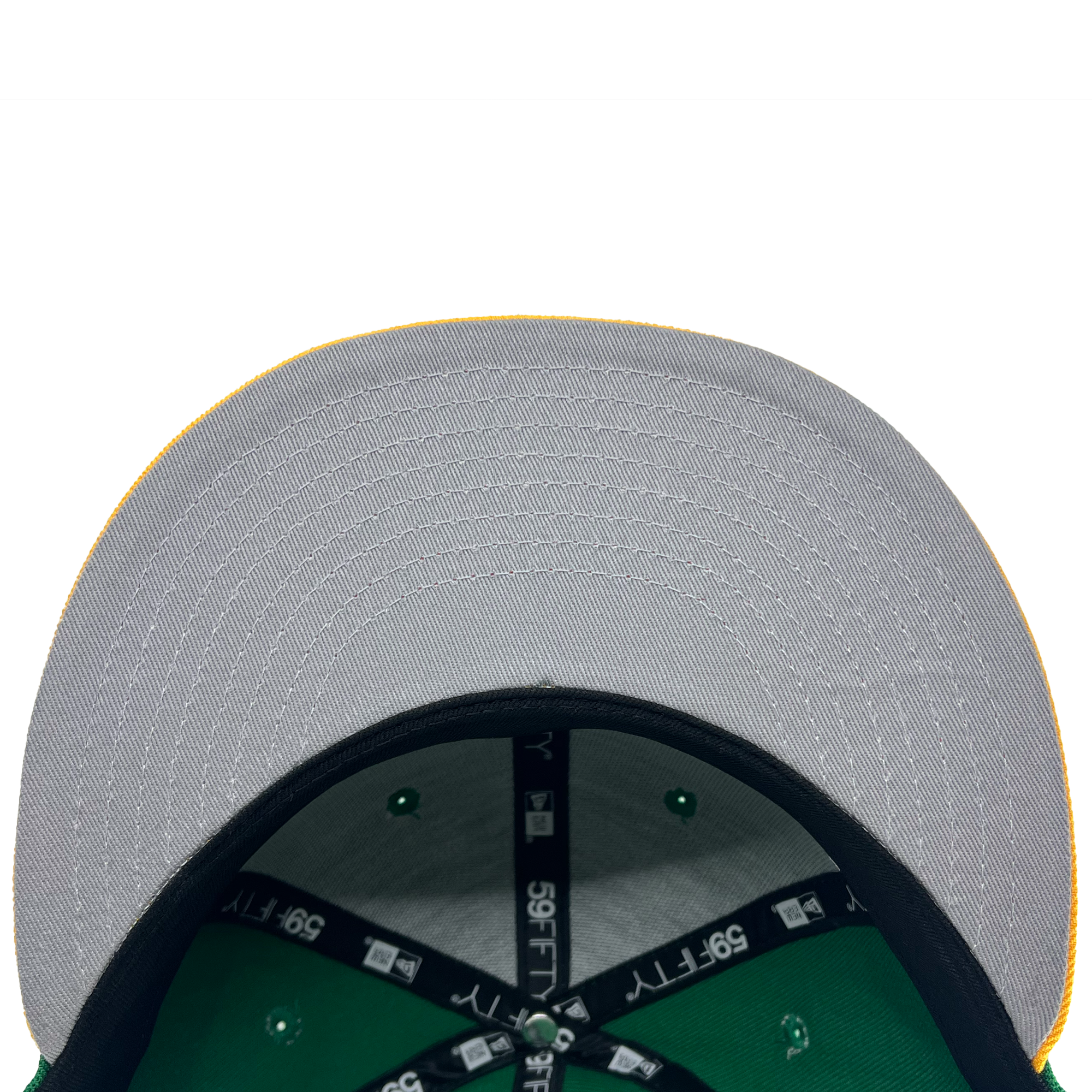 A close-up view of the underside of a New Era Oakland Ballers 59Fifty Cap's brim from their Pioneer League days. The brim is gray with visible stitching and a yellow edge. The interior showcases green fabric and black bands labeled "39THIRTY." Rivets on the green fabric are also evident, against a white background.