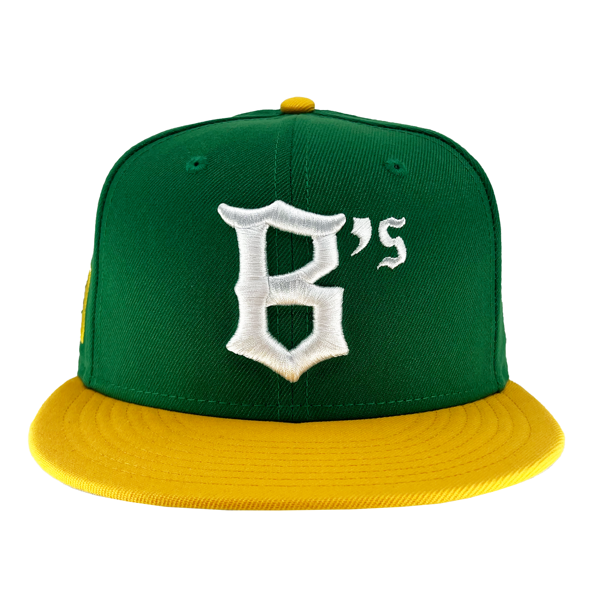 The New Era Oakland Ballers 59Fifty Cap features a green body with a flat yellow brim and a top button that matches in yellow. The front of the cap showcases a white, stylized letter "B" followed by a smaller white "'s," symbolizing the Oakland Ballers. The image background is white.