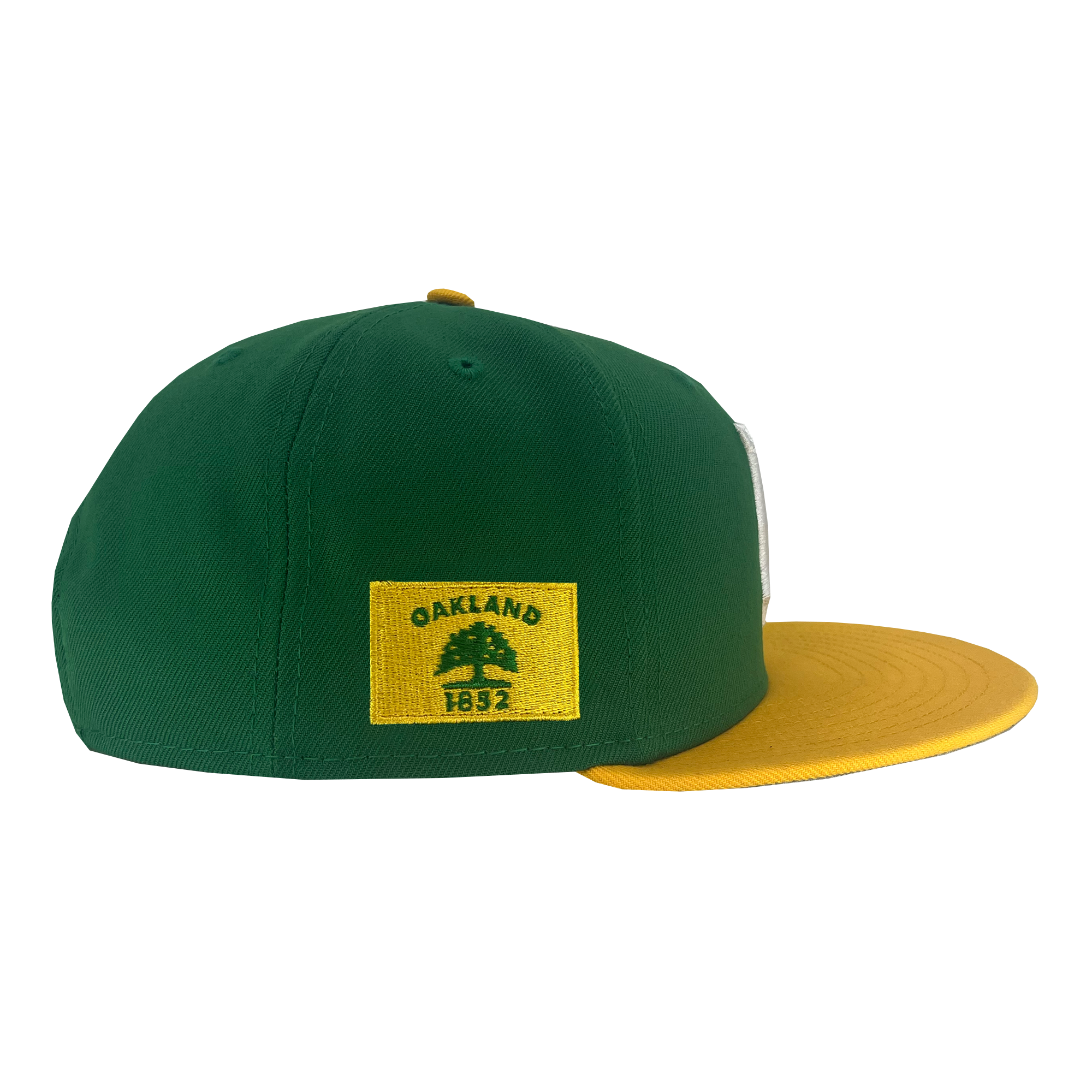 A New Era Oakland Ballers 9FIFTY Cap is angled to show its side. The cap features a green crown and a yellow brim. On the left side of the cap, there is a yellow rectangular patch with a green tree and "OAKLAND 1852." Perfect for fans of Oakland's new pro baseball team in the Pioneer League, even the top button and eyelets are yellow.