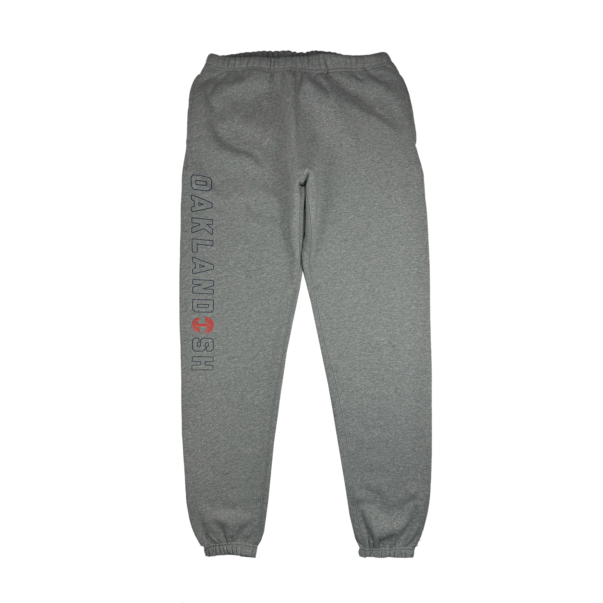 The Bandit Sweatpants by Oaklandish are gray, unisex sweatpants featuring an elastic waistband and cuffs. The design includes "OAKLANDISH" in black vertically on the left leg and a red circular symbol similar to a tree ring. These sweatpants also offer a hidden zipper pocket for added convenience and are displayed flat against a white background.