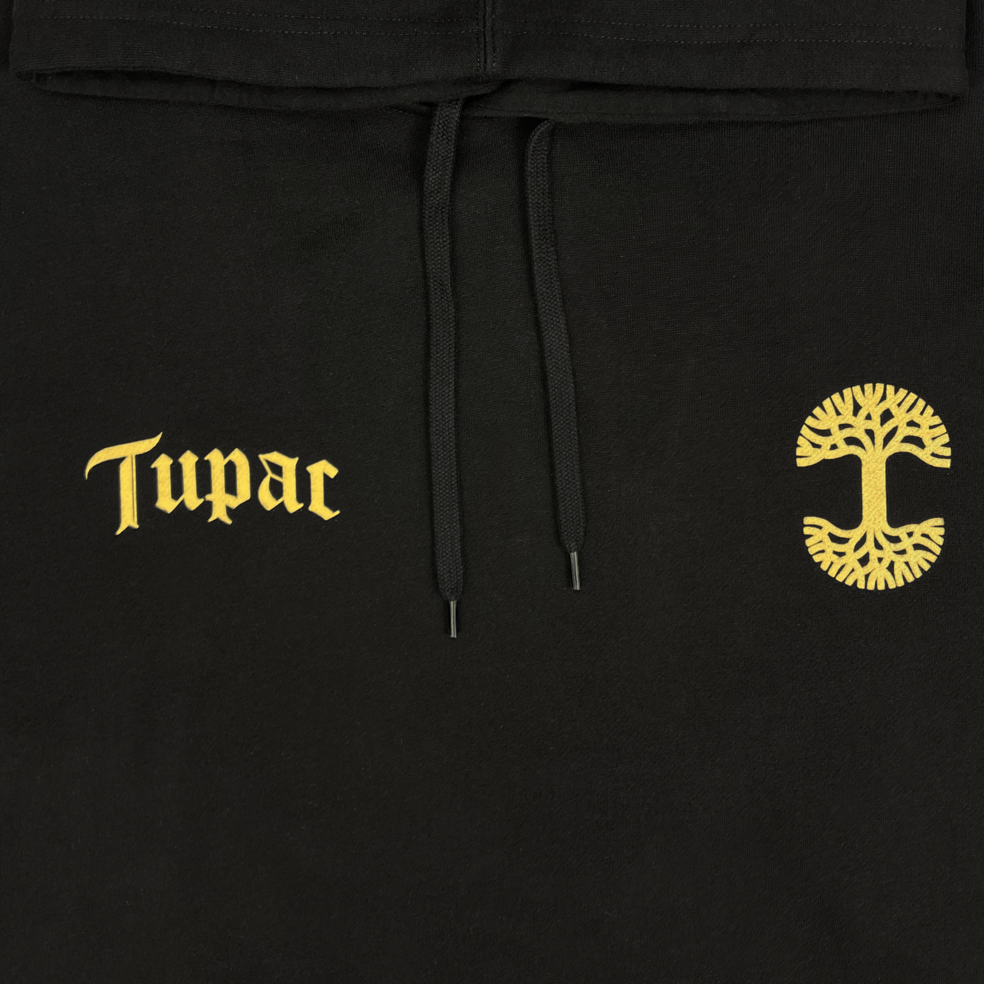 Introducing the Bless Hoodie from Oaklandish, an exclusive piece from our hip-hop collection. This black hoodie is part of our collaboration and proudly displays "Tupac" in ornate gold lettering on the left side. On the right side, it features a distinctive round gold emblem inspired by Oaklandish with a tree design. The hoodie is completed with black drawstrings at the neck for added style and comfort.