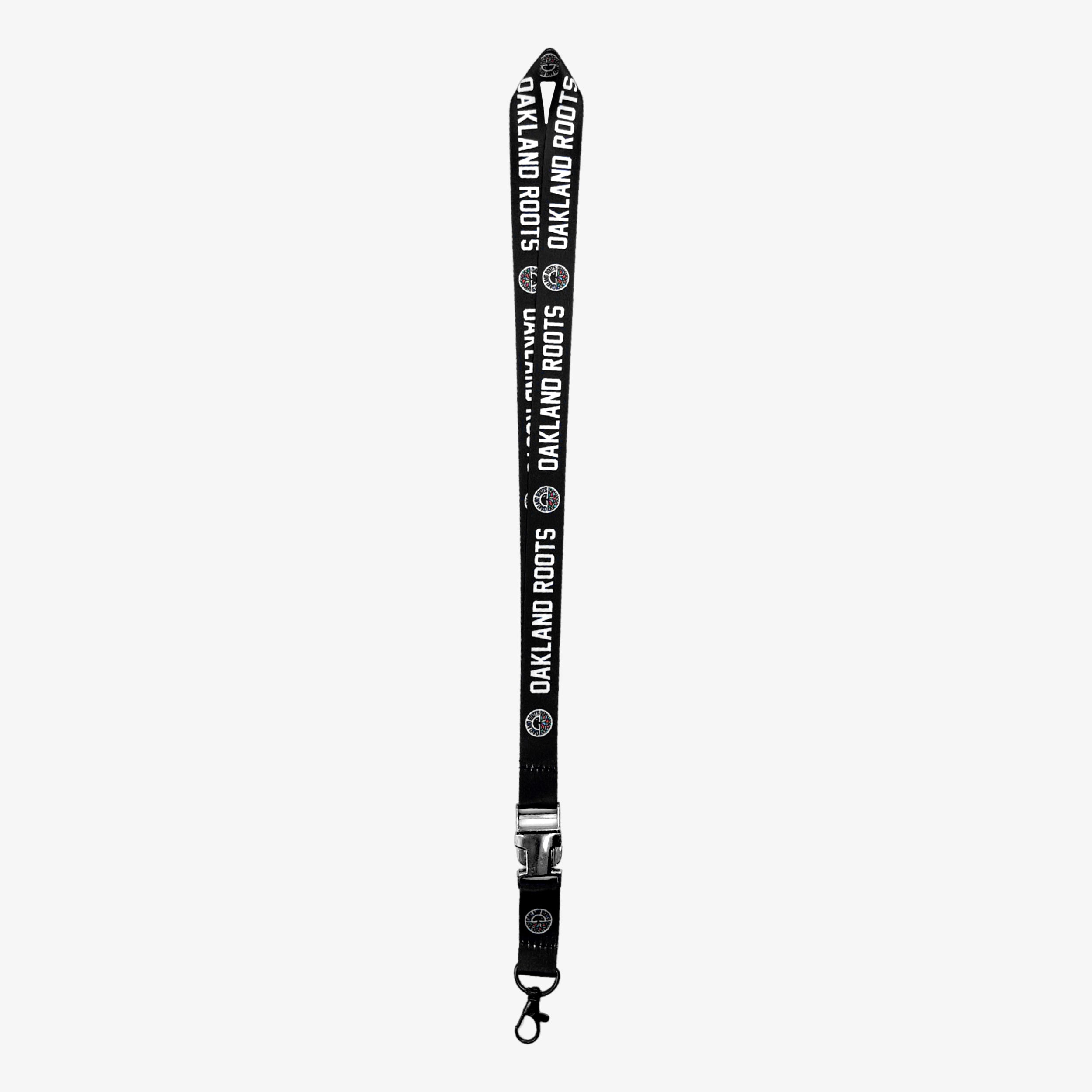 The "Oakland Roots SC VIP Lanyard" by Oakland Roots SC is a black lanyard adorned with a repeating white logo and text pattern that says "Oakland Roots Sports Club." It includes a metal clasp at the end for attaching keys or ID cards, along with a black plastic safety buckle near the clasp.