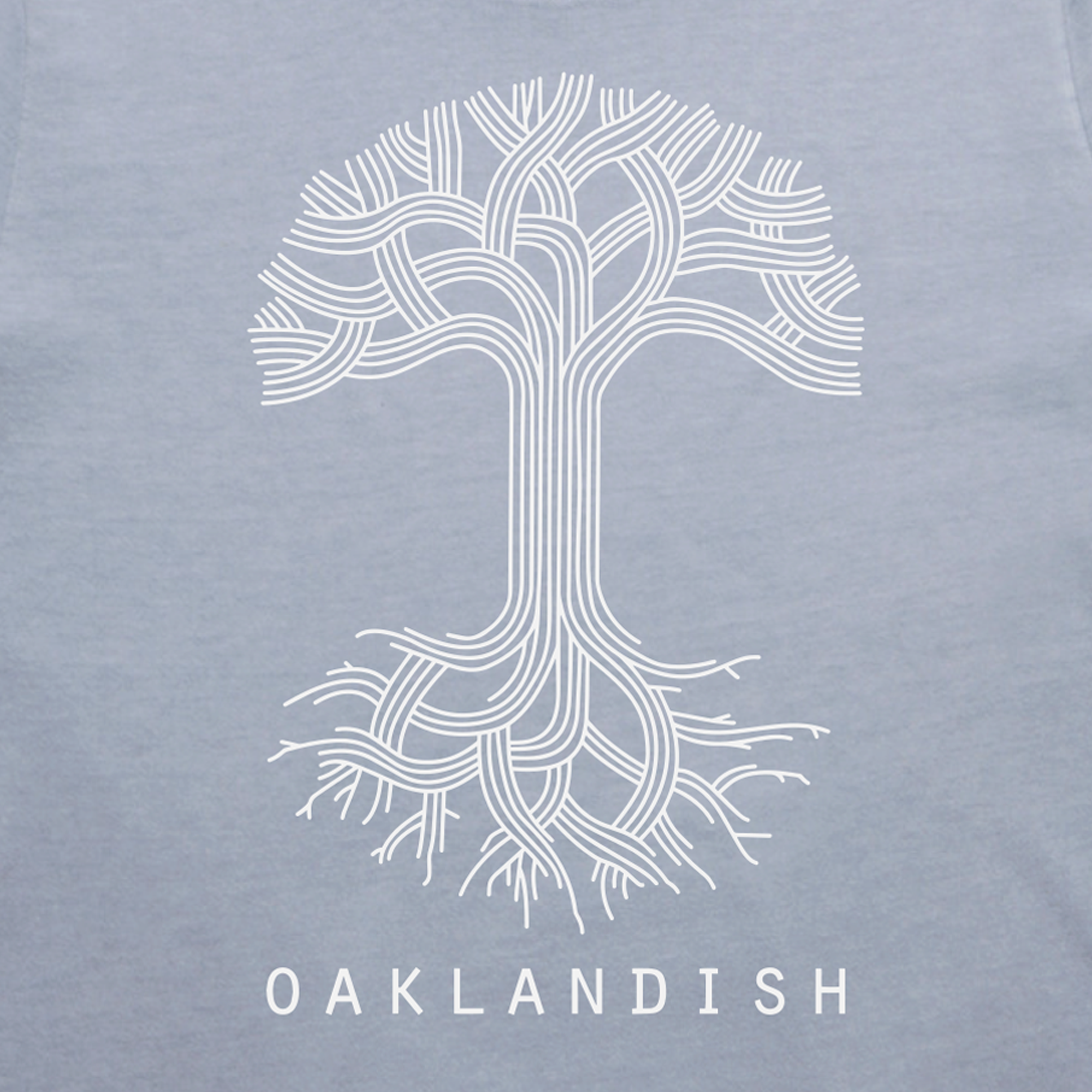 This women's classic fit t-shirt from Oaklandish features a stylized white tree with intricate branching roots and limbs set against a light gray background. The branches form a circular canopy, mirrored by equally complex roots below. Beneath the tree, "OAKLANDISH" is displayed in bold white letters, all printed on a 100% cotton tee.