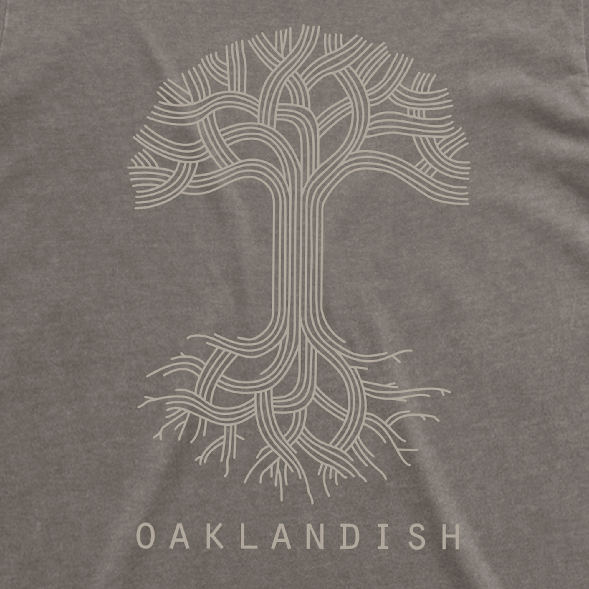 The Women's Oaklandish Classic Logo Heavy Tee by Oaklandish features an intricately styled white tree graphic with detailed branches and roots, centered on a dark gray background. The word "OAKLANDISH" is prominently displayed in bold, white capital letters below the tree, complemented by wide neck ribbing for enhanced style.