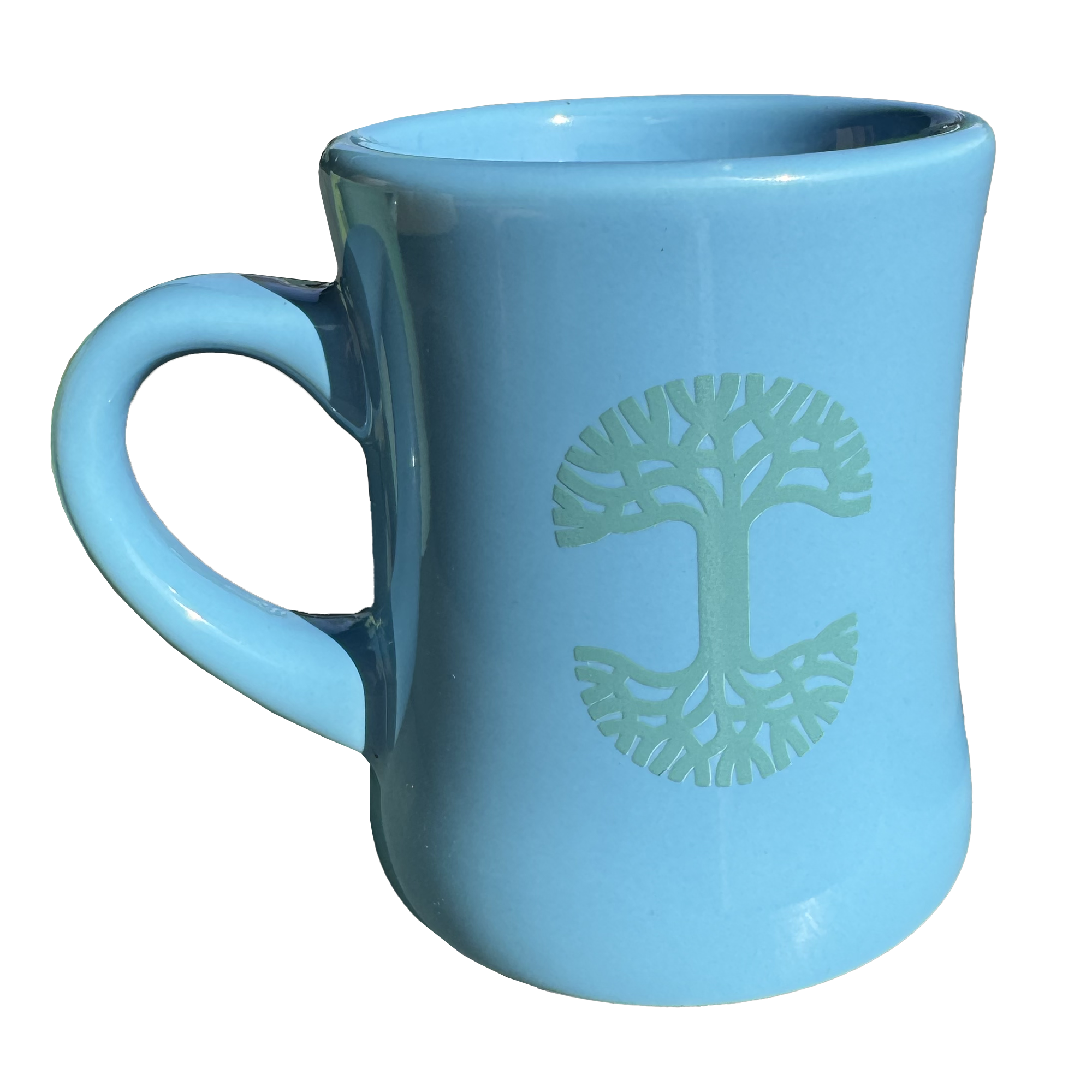 The Oaklandish Diner Mug is a light blue ceramic piece with a wide base and a narrow top, making it ideal for any drinkware collection. It features a green geometric tree design on one side, while the handle takes on a simple half-heart shape, set beautifully against a plain white background.