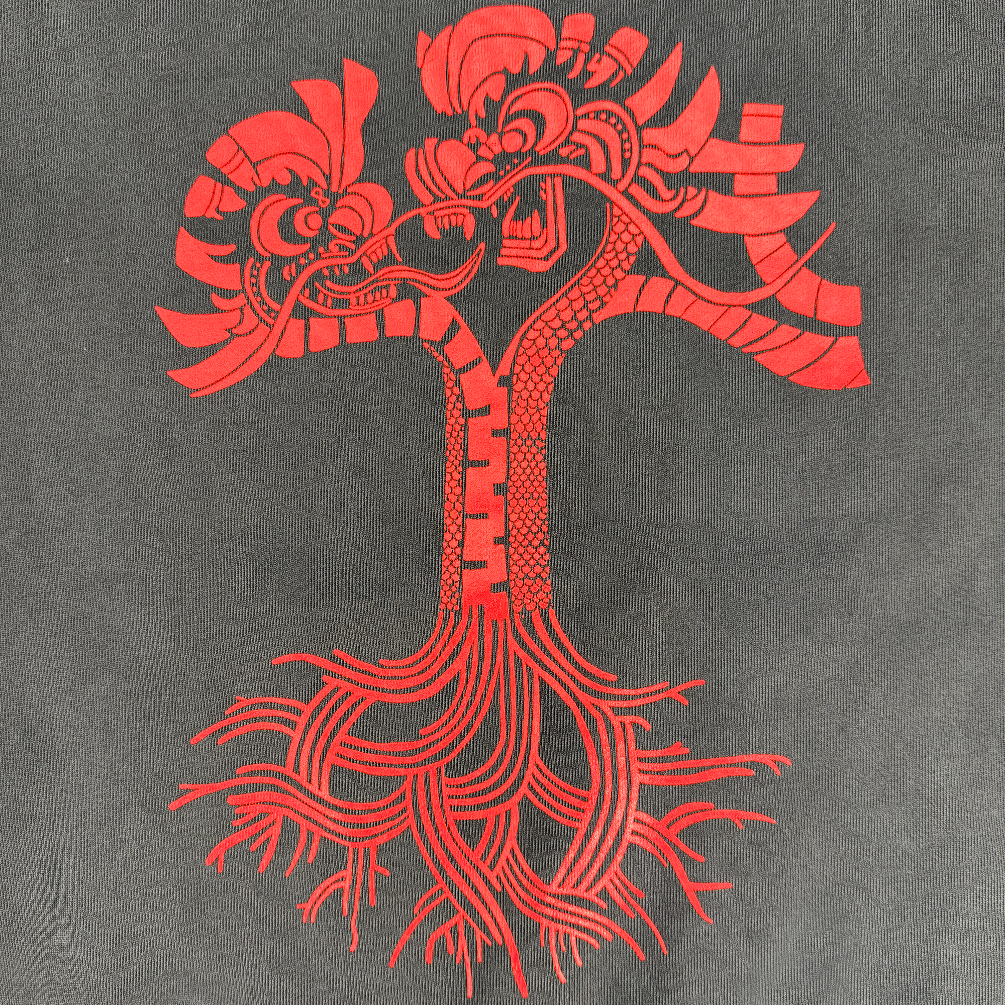 The Dragon Power Hoodie by Oaklandish displays a red abstract twin-headed dragon on a gray background. Its entwined bodies form a tree with swirls and roots, encircled by flames, evoking Oakland Chinatown's vibrant cultural heritage.