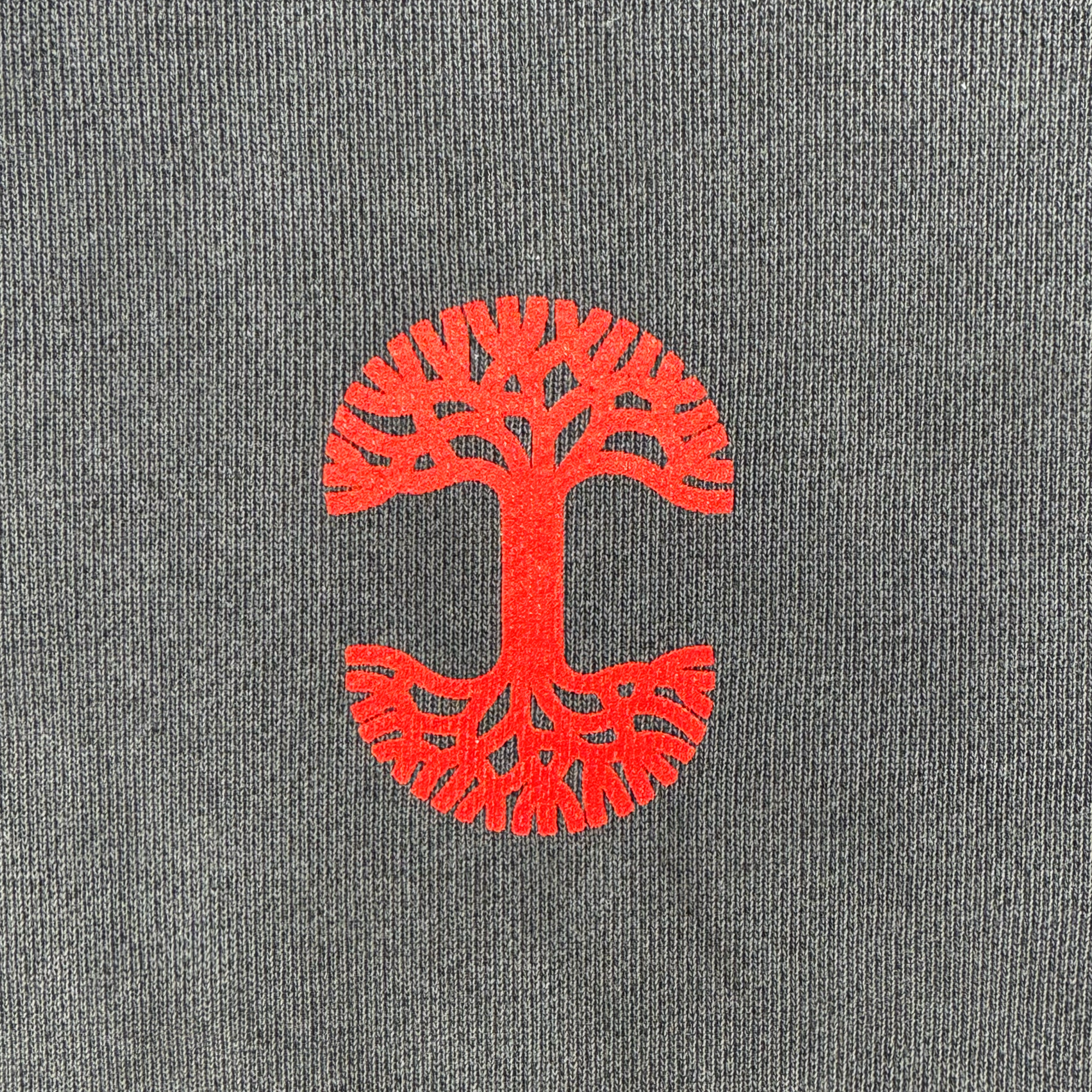 The Dragon Power Hoodie by Oaklandish features a bold, red tree of life design on a gray background, symbolizing Chinese American heritage. With symmetrical branches reaching upward and roots extending downward in a rounded form, the simplistic design stands out against the neutral gray tone.