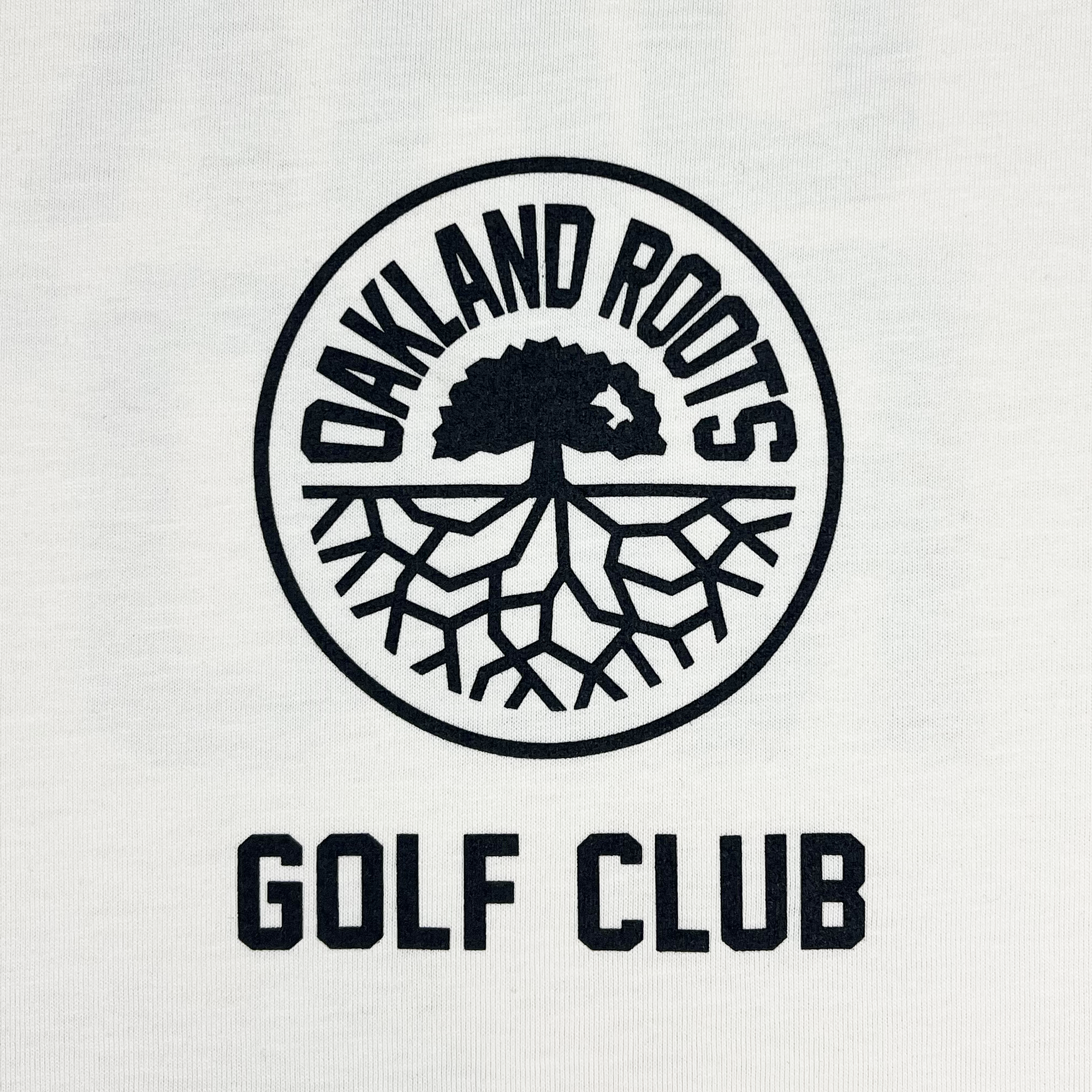 A circular logo featuring a tree with roots extending downward is centered on a white background. The words "OAKLAND ROOTS SC" curve around the top inside the circle, highlighting its commitment to social good. Below the emblem, "GOLF CLUB TEE" is written in bold, uppercase letters. The design is in black ink.