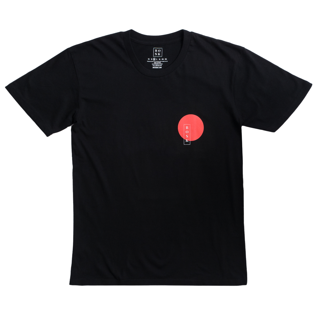 The Misty Tee by BOSK is a classic fit, black T-shirt made from heavy-weight cotton. It features a small red circle with a vertical white rectangle inside on the left chest area, complemented by a round neckline and short sleeves.