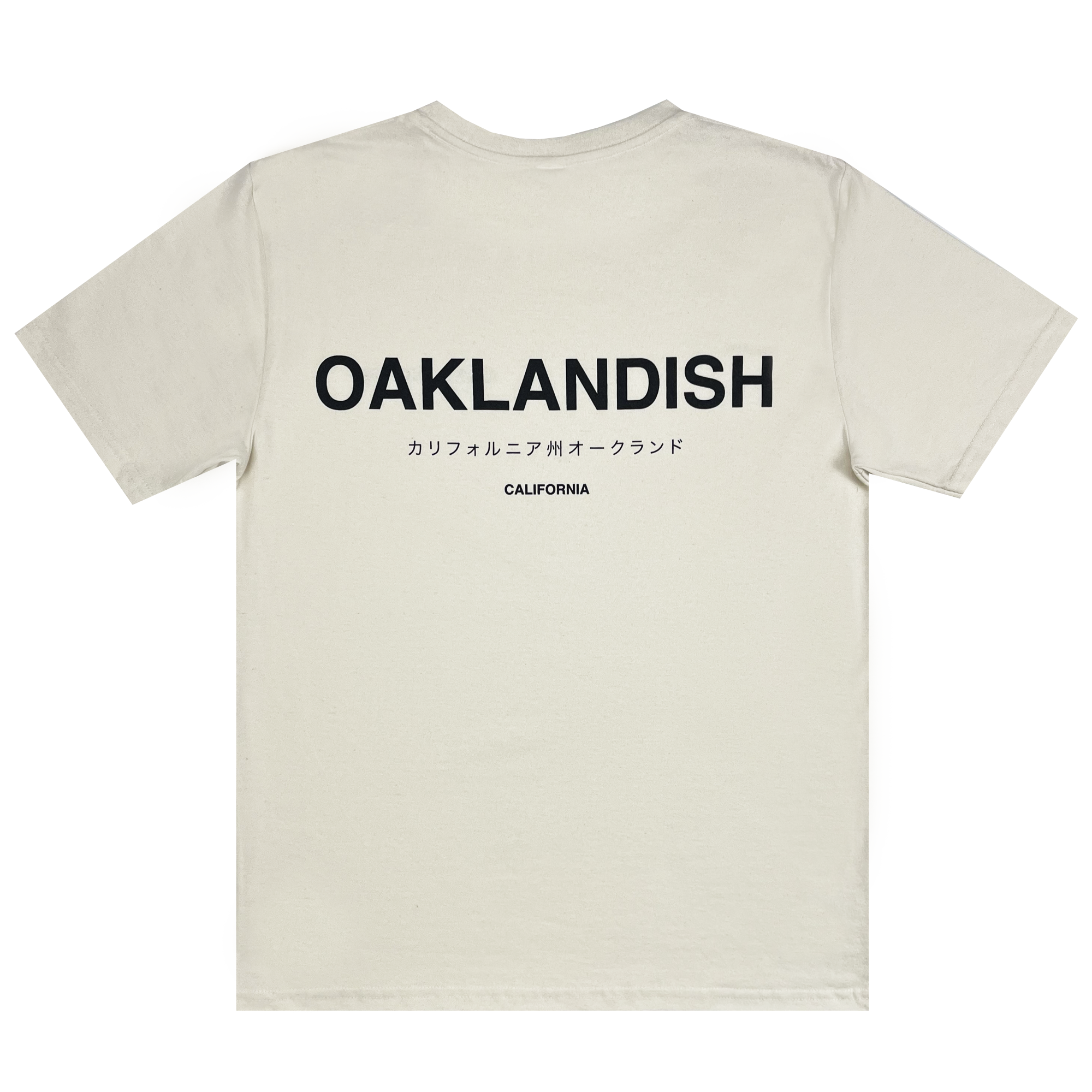 This classic fit, 100% cotton, beige short-sleeve Modern Type Tee from Oaklandish's men's collection features "OAKLANDISH" in large, bold black letters on the upper back. Below it, Japanese characters and the word "CALIFORNIA" are centered in smaller black letters. The t-shirt is laid flat with the back side facing up against a white background.