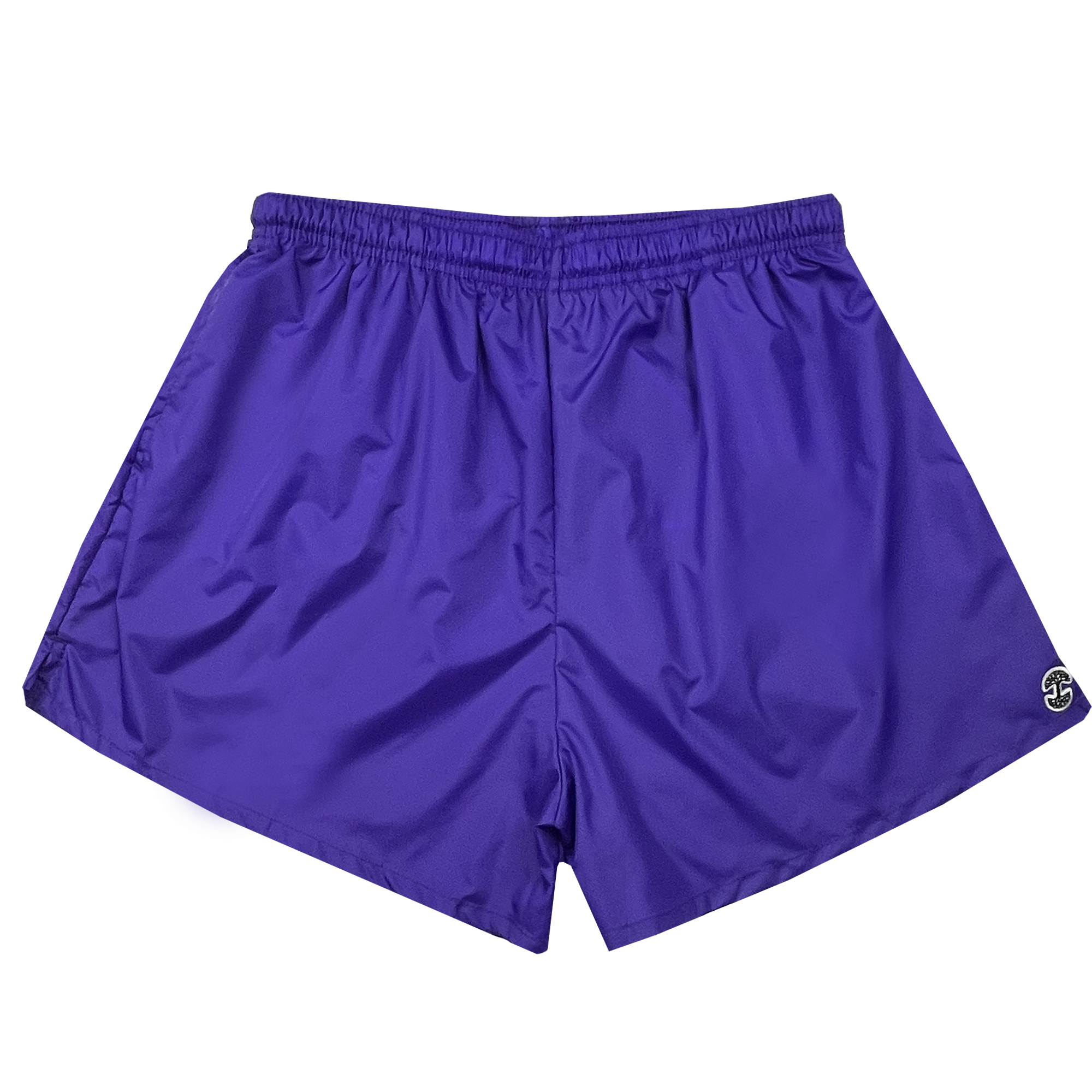 The Women's Bandit Nylon Shorts from Oaklandish are crafted from purple nylon taffeta and feature an adjustable waistband, along with a small, circular embroidered logo at the bottom hem on the right side. The lightweight fabric has a slightly wrinkled texture, making these shorts ideal for sports or casual wear. They offer a simple and functional design without extra features or embellishments.