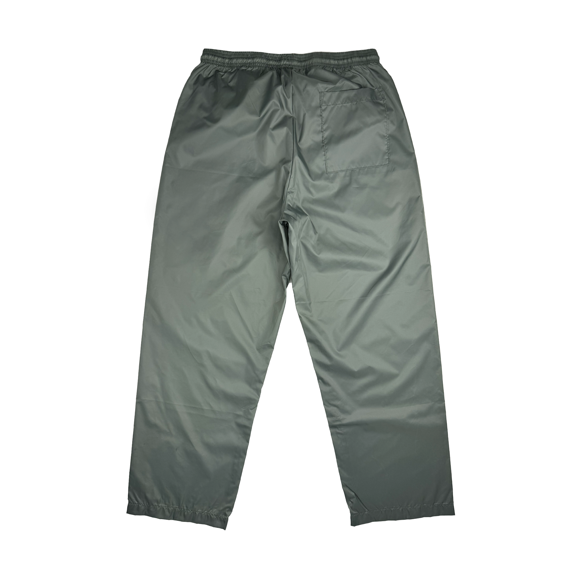 The Bandit Nylon Pant by Oaklandish boasts a sleek design with its gray waterproof nylon taffeta material, displayed against a white background. Its slightly shiny texture enhances the aesthetic, while an adjustable elastic waistband and right-side pocket add practicality. The baggy fit, featuring straight legs and elasticated hems, completes the look.