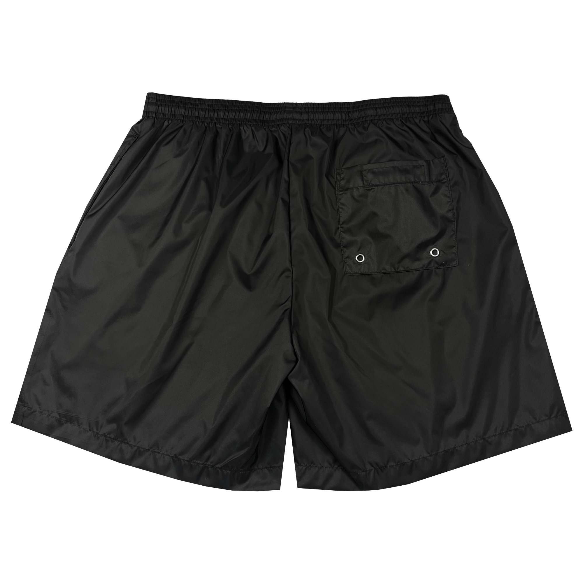 The Oaklandish Bandit Nylon Short is a pair of black, lightweight nylon taffeta shorts viewed from the rear. These stylish shorts feature an elastic waistband, a single back pocket with a flap and two metal eyelets for ventilation. The fabric has a subtle sheen, giving it a sporty look. The hem is slightly rounded, and the stitching is visible.