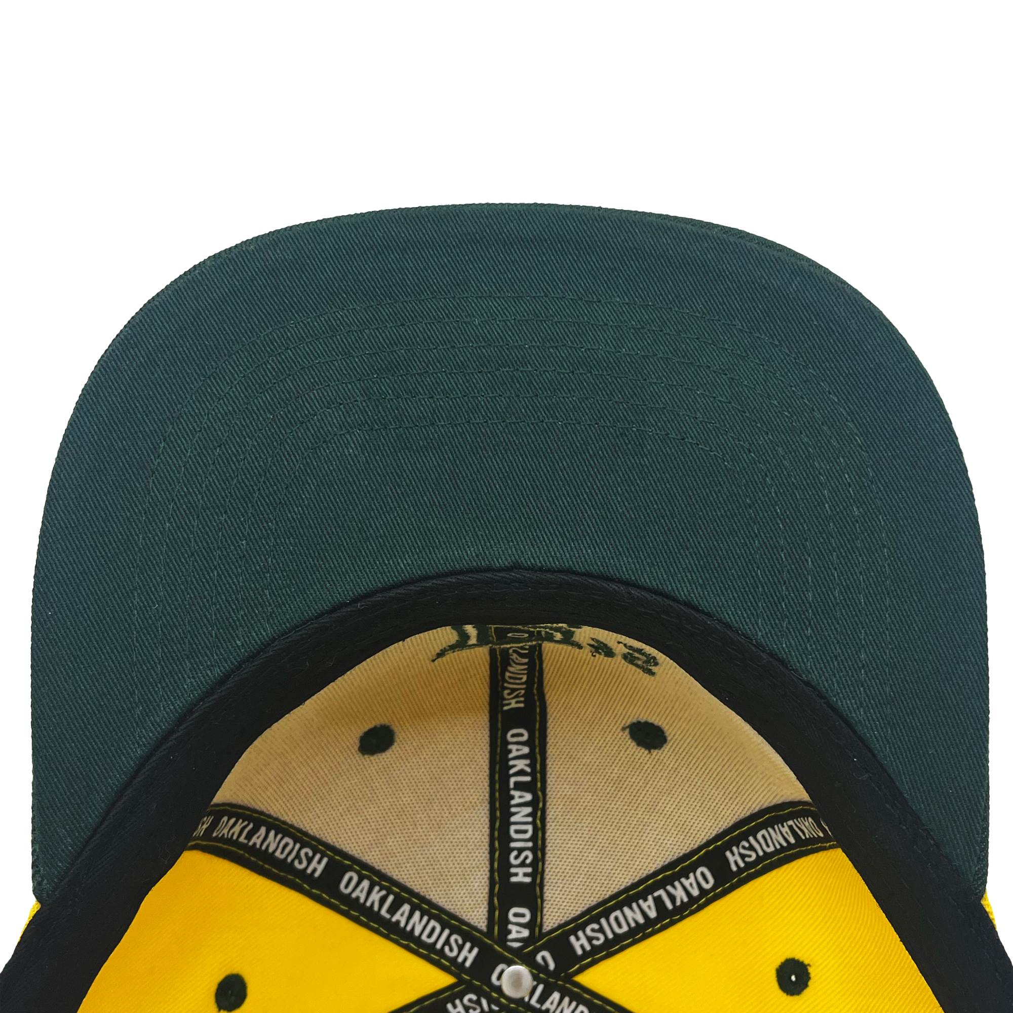 Close-up view of the interior of the Oakland Ballers Snapback. The brim is dark green, and the inside features a beige lining with black trims that read "OAKLANDISH" in a repeating pattern. Reminiscent of Oakland Ballers' gear, the inner crown is supported by black panels and stitching, giving it a structured look.