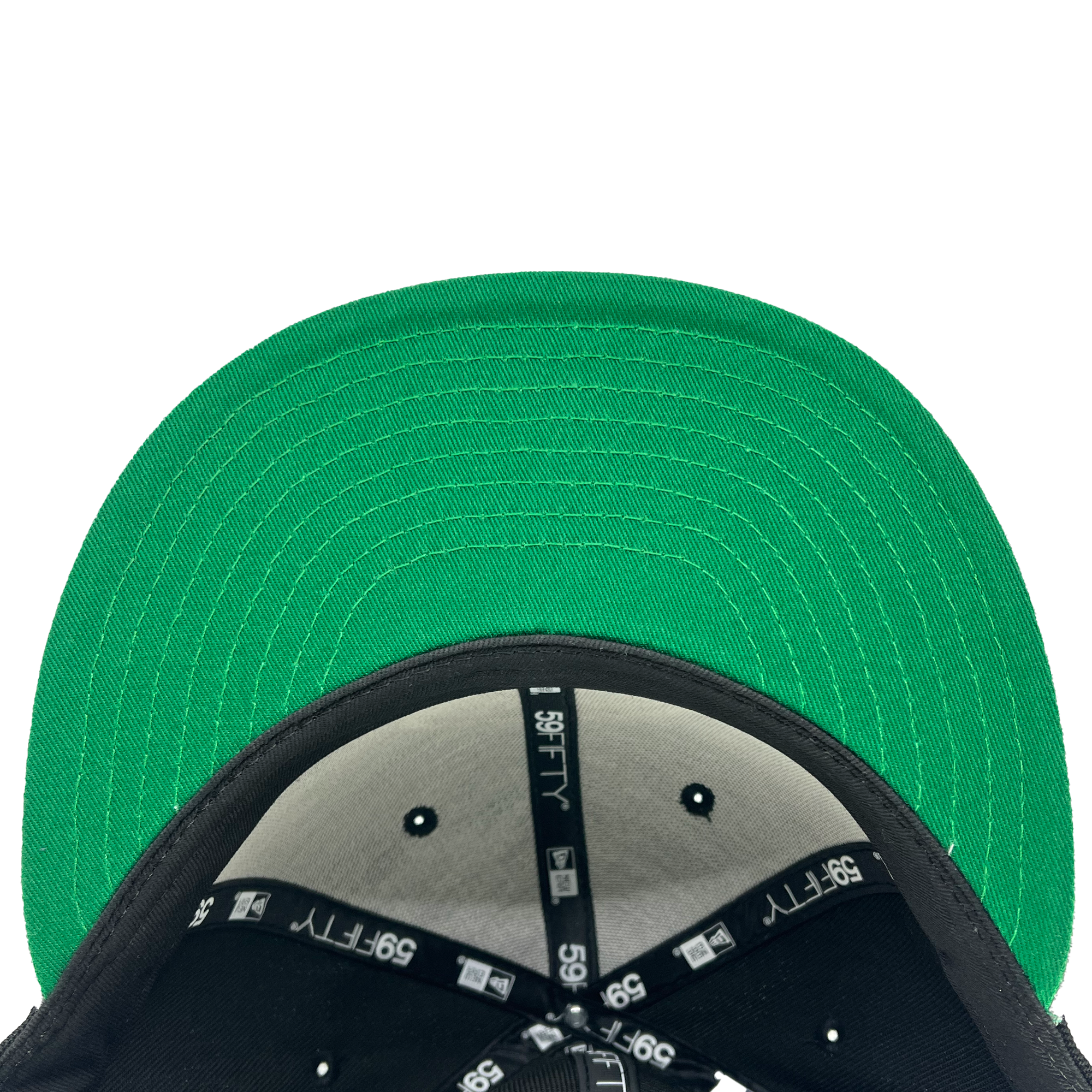 A close-up view of the inside of a New Era Oakland Roots SC 59FIFTY Cap, commonly seen among fans of the Oakland Roots sports club. The interior is lined with black fabric featuring white "59FIFTY" and "New Era" logos along the seams, while the green underside of the brim displays multiple concentric stitching lines.