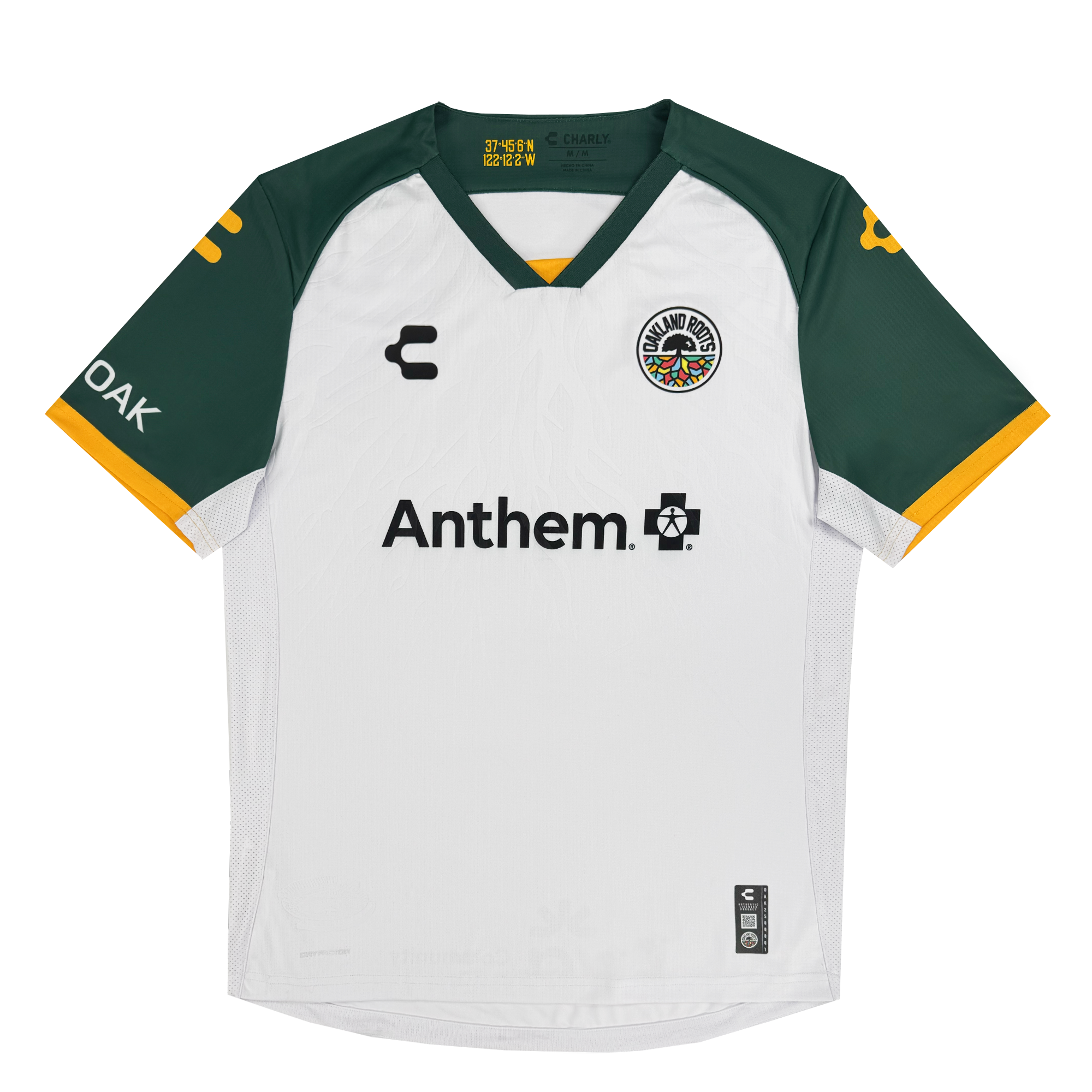 The Unisex Oakland Roots SC 2025 Second Kit features a white and dark green jersey inspired by Oakland sports history. It has dark green short sleeves with yellow trim and logos, a circular emblem, "Charly" logo, "Anthem" with a cross symbol, and Oakland Roots SC branding.