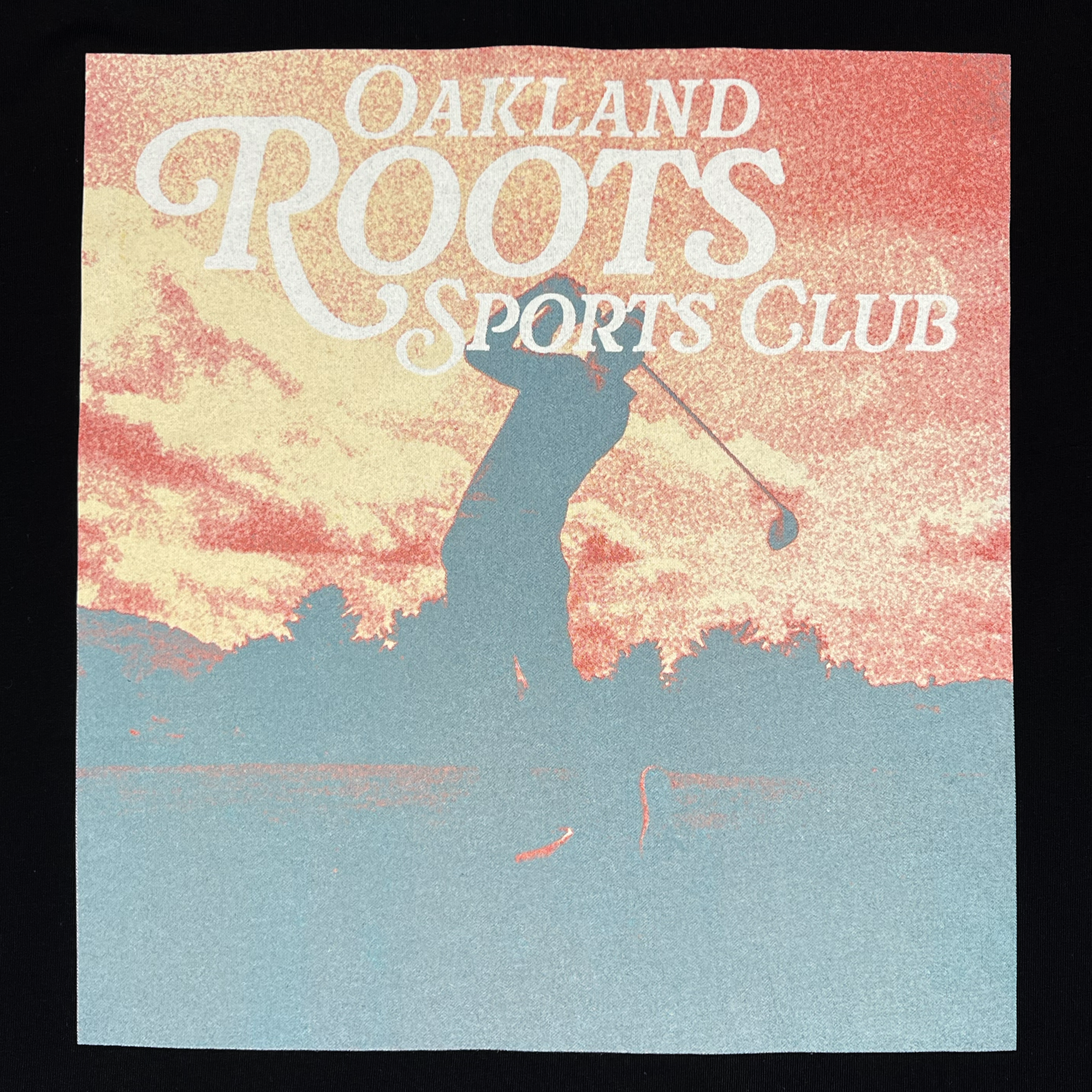 A stylized image features the silhouette of a person playing golf against a sunset backdrop with orange and yellow hues. "Oakland Roots SC" is displayed at the top in large, white decorative letters. The background transitions from dark blue to warm tones, embodying the spirit of this inspiring Legacy Golf Tee.