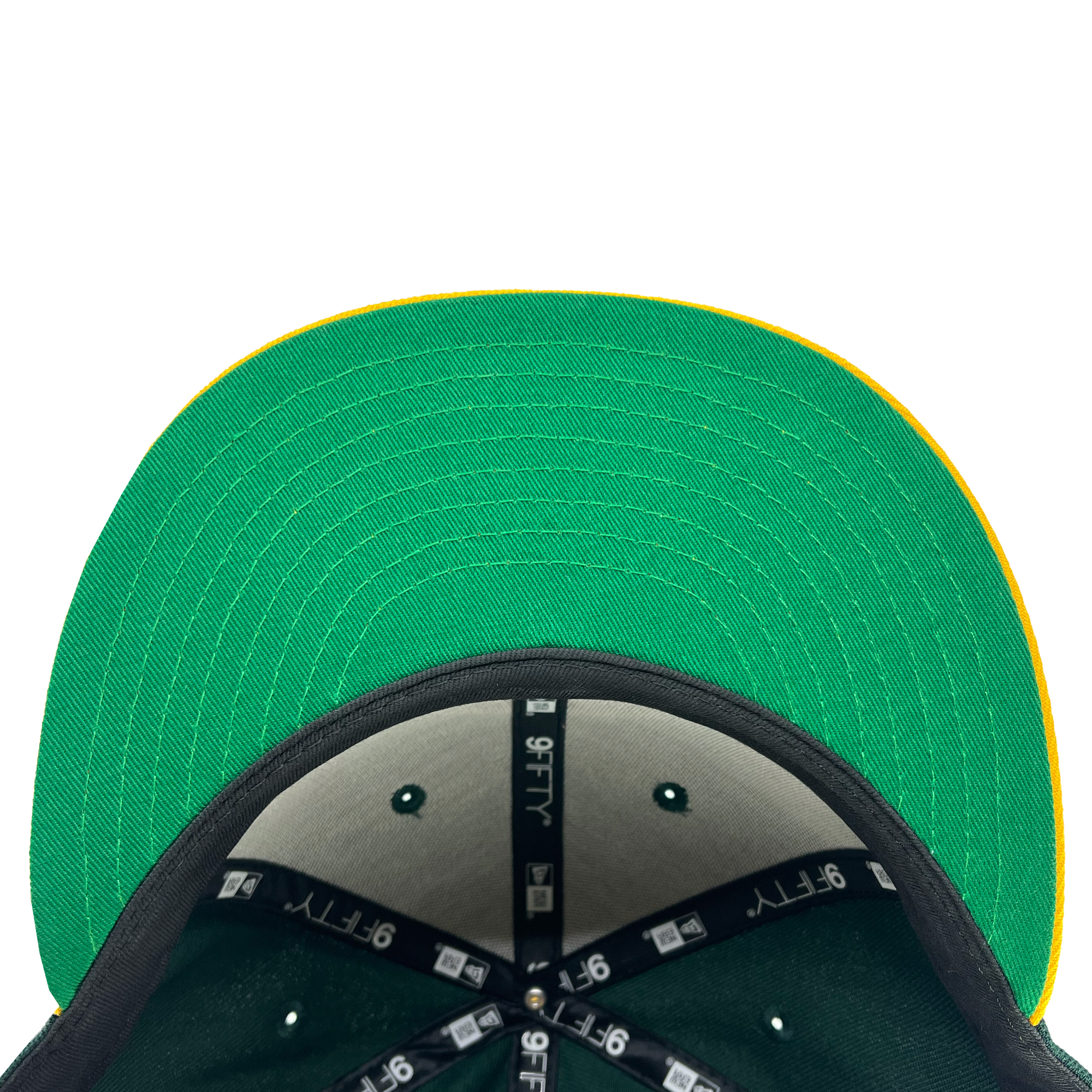 A top view of the New Era Oakland Roots SC 9FIFTY Cap reveals a stylish green flat-brim with a yellow edge. Inside, black fabric is accented with "9FIFTY" text and logos on the seams. Green stitching lines highlight the visible part of the underbrim. Set against a plain white background, this cap is perfect for any Oakland Roots SC fan.