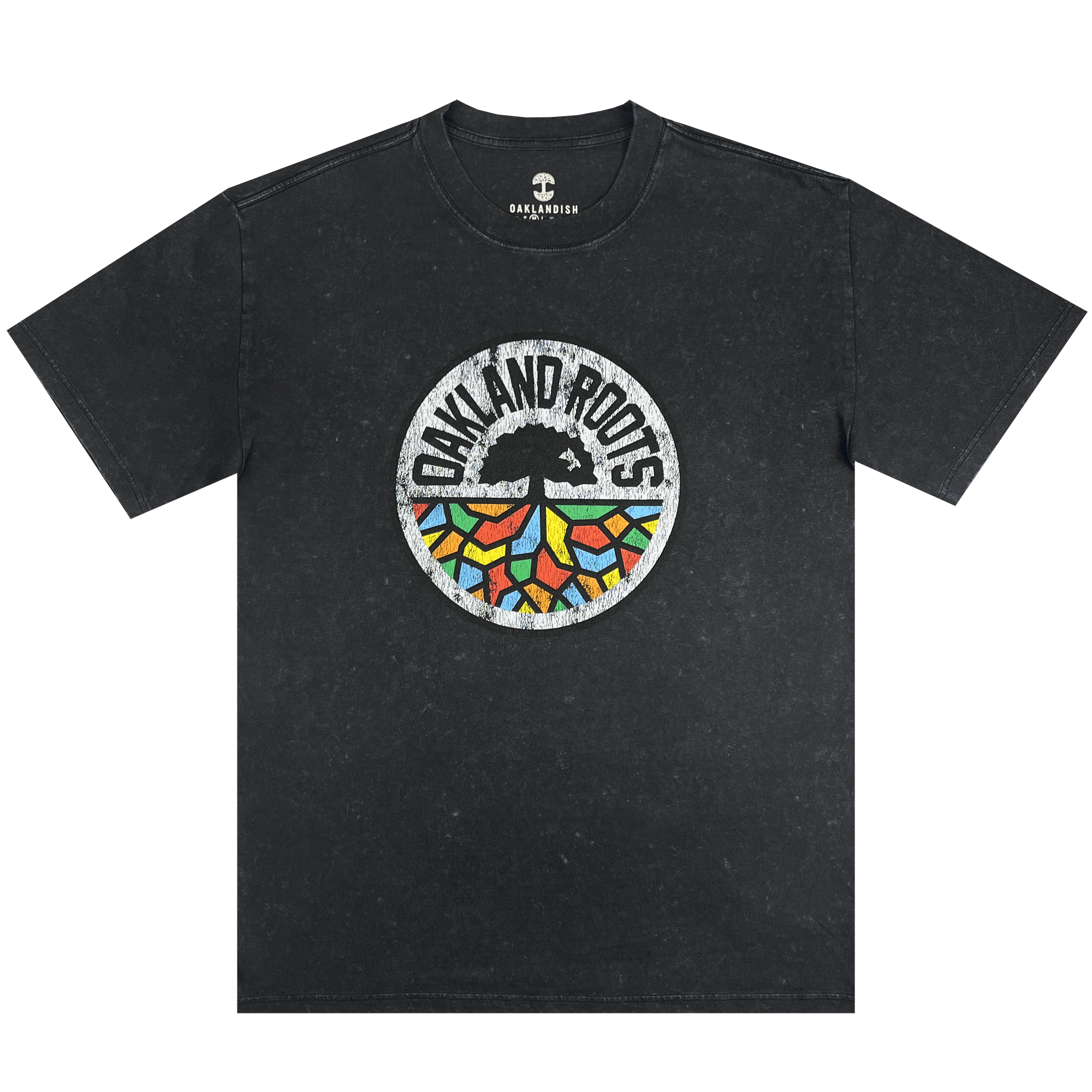 The Oakland Roots SC Classic Heavy Stone Wash Tee is a black, short-sleeved T-shirt that features a central circular logo. The logo showcases an abstract tree design with vibrant, geometric leaves and the text "Oakland Roots" arched above it, symbolizing the sports club's dedication to social good. The Oaklandish brand logo is printed near the collar for an added touch of authenticity.