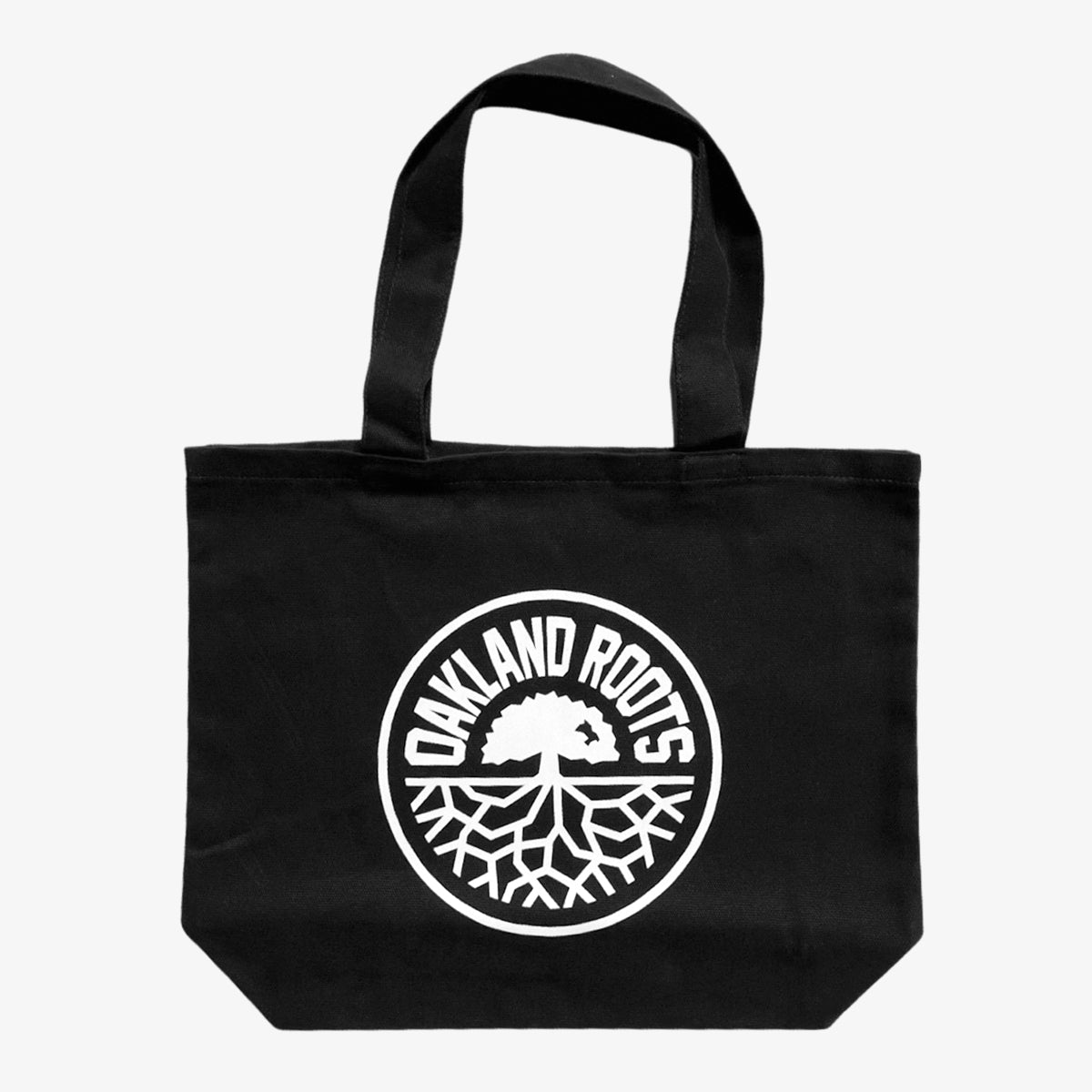 Introducing the Oakland Roots SC Tote by Oakland Roots SC: This black tote bag showcases a circular white emblem at its center, featuring a stylized image of a tree with spreading roots. Encircling the design are the bold, uppercase words "OAKLAND ROOTS." Ideal for fans of the local sports club, it includes two black handles for easy carrying.