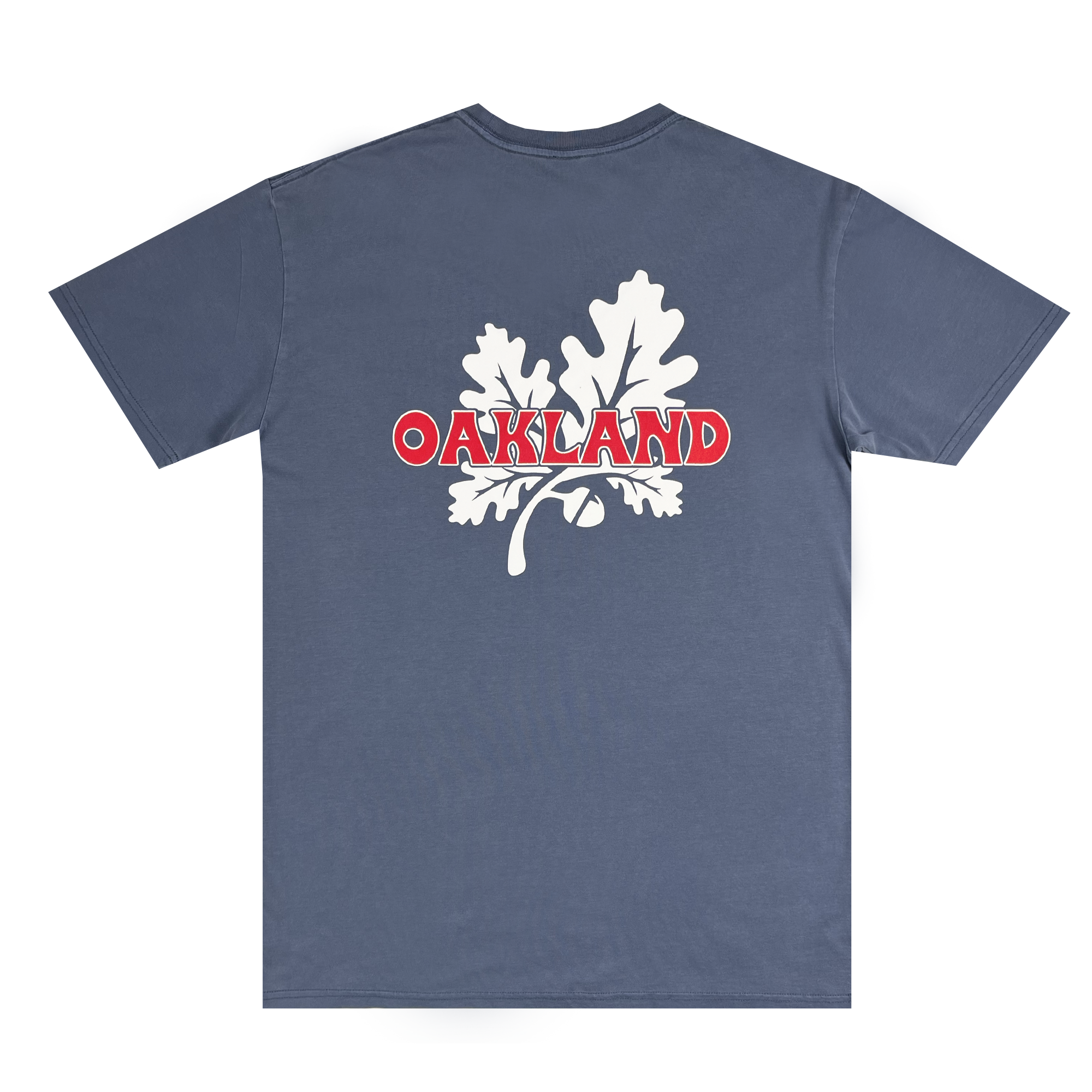 Introducing the Grocery Run Tee by Oaklandish: a classic fit blue short-sleeve T-shirt featuring a striking white oak leaf design at its center back. The word "OAKLAND" is displayed prominently in bold red and white letters across the leaf. Made from 100% cotton, this shirt is presented flat to highlight its pristine quality.