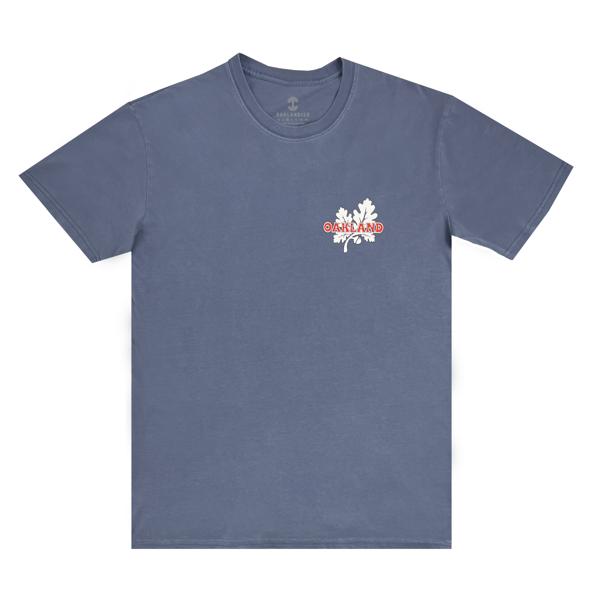 The Oaklandish Grocery Run Tee is a plain blue, 100% cotton T-shirt featuring a small design on the left chest area. The design includes white oak leaves with the word "OAKLAND" in bold red letters overlaying them. This classic fit tee has a simple, casual crew neck style and offers a fresh look for any casual outing.