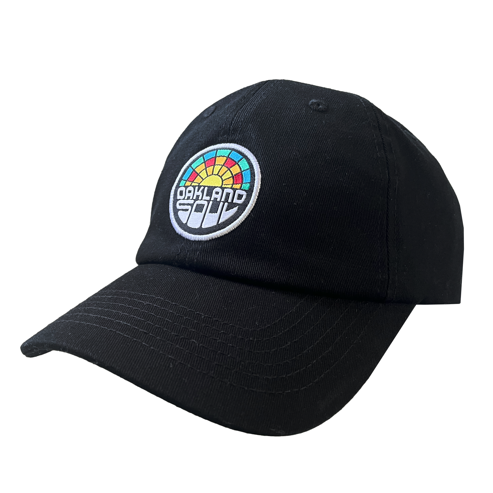 The Oakland Soul Dad Hat is a black baseball cap adorned with a multicolored circular patch on the front. The patch showcases the text "OAKLAND" in white and "SOUL" in black, set against a rainbow design featuring red, orange, yellow, green, and blue segments. This cap celebrates the Oakland Soul women's soccer team in the USL W-League.