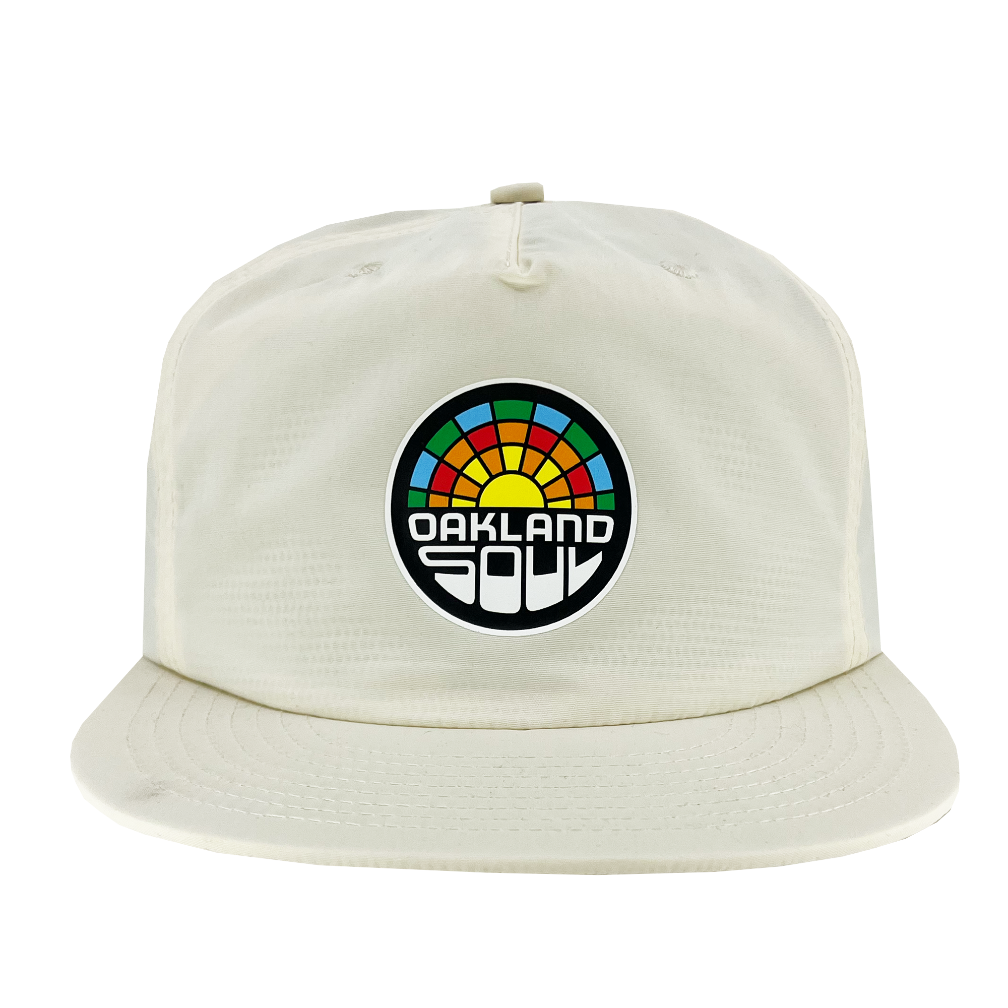 The Oakland Soul Surf Cap, a white baseball cap with a flat brim, showcases a circular logo on the front. The logo features a colorful, semi-circular design resembling a sunrise or rainbow with "OAKLAND SOUL" in bold white letters against a black background, celebrating Oakland Soul, our women's soccer team in the USL W-League.