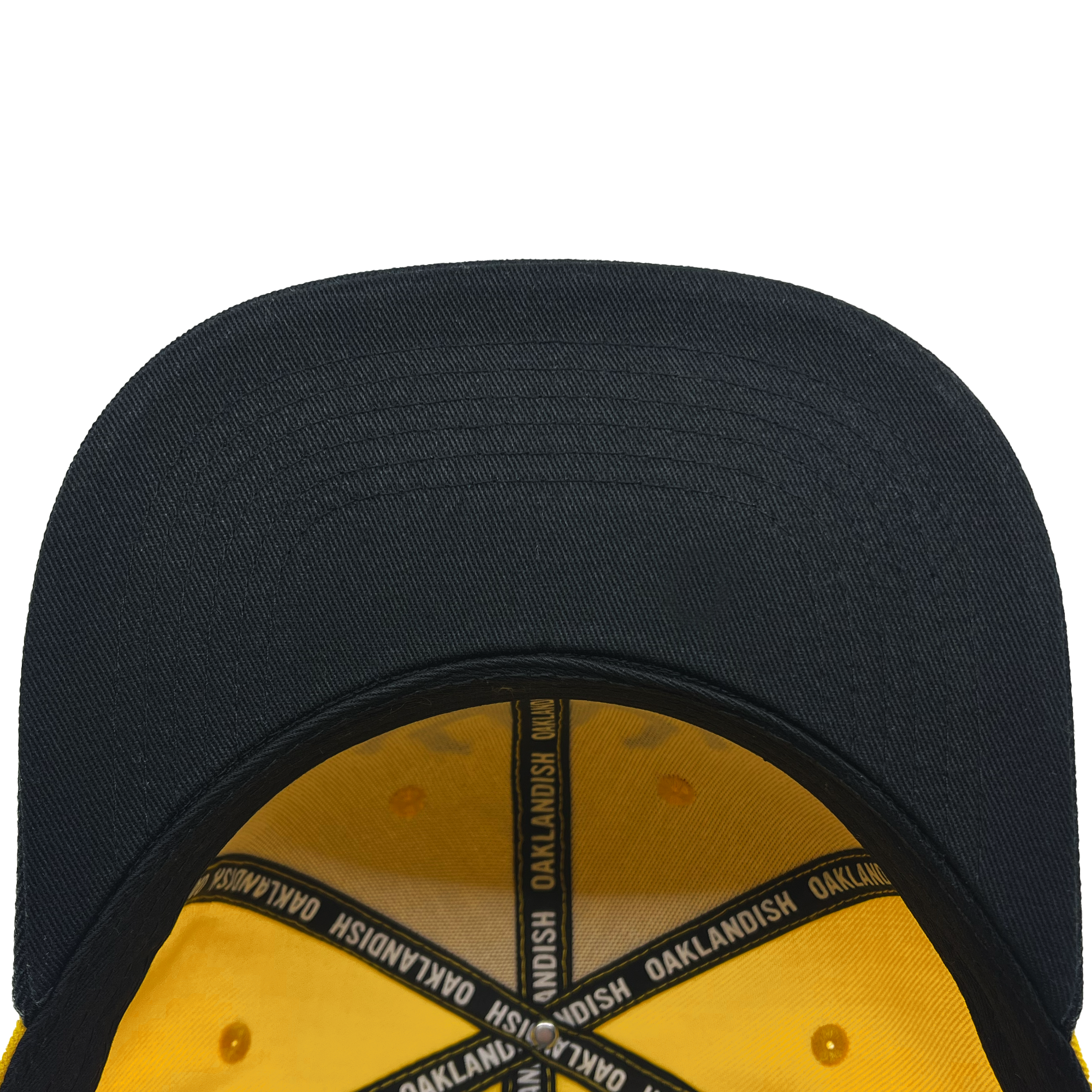 Inside view of black bill yellow snapback hat with Oaklandish taping.